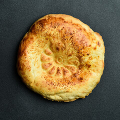 Pita bread on dark background. Arabic, Lebanese bread, traditional food. Close-up, dark background.