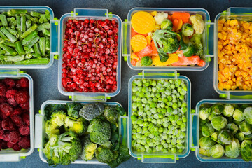 Background of frozen vegetables and fruits. Variety of frozen food for the winter. Top view. Free space for text.