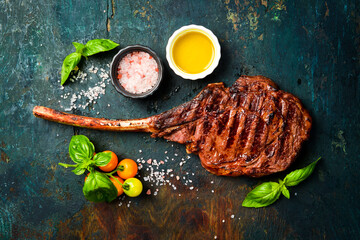 Tomahawk Black Agus steak with sea salt, butter and spices. Juicy steak grilled. Top view.