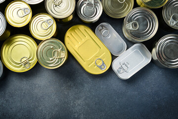 Aluminum cans with canned goods. A large set of canned goods in cans. On a gray background.