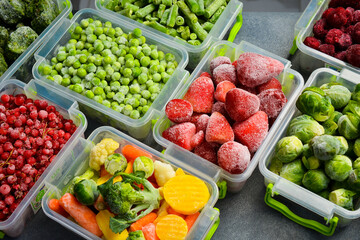 Assortment of frozen vegetables in plastic boxes. Preparing food for the winter.