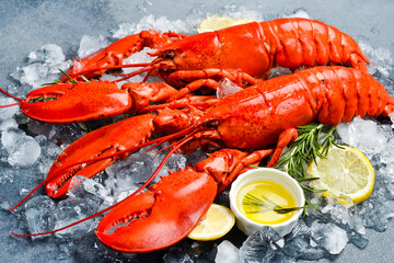 Steamed red lobsters with lemon, ready to eat. Side view. Close-up.