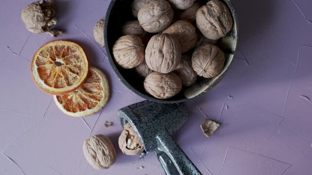 shelled walnuts and metal nutcracker in close-up