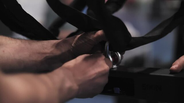 Hands securing stage equipment with safety cables