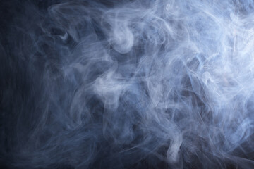 Abstract smoke texture over black background. Fog in the darkness.
