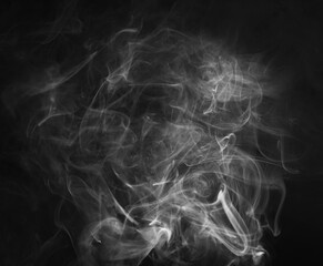 Abstract smoke texture over black background. Fog in the darkness.