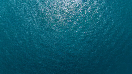 Aerial zenith view of the deep and blue water of the sea. Empty surface of water. Ideal for textures, patterns and backgrounds.