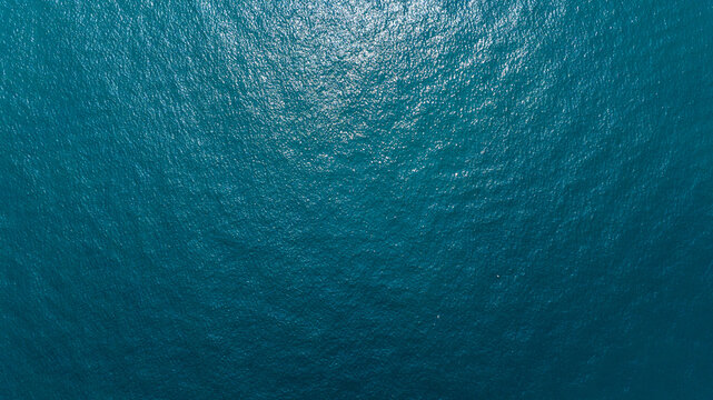Aerial zenith view of the deep and blue water of the sea. Empty surface of water. Ideal for textures, patterns and backgrounds. - Powered by Adobe