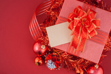 Red Christmas gift box with blank card and decorations
