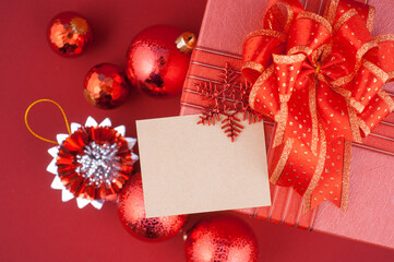 Red Christmas gift box with blank card and ornaments