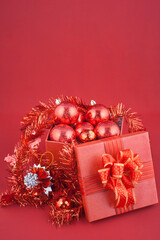 Red Christmas Gift Box with Ornaments and Tinsel
