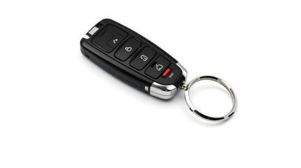 A modern black car key fob with a silver keychain rests on a crisp white background studio shot.