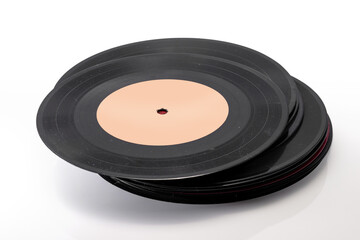 Stack of vintage black vinyl records with blank white labels on a white background, perfect for...