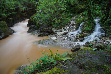 flowing water in a creek over the mountains in tuscany