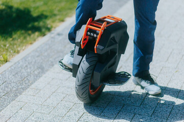 One-wheel electric transport and man's legs in sunny park © Alexandr