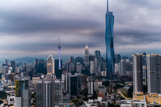 Fototapeta Modern skyscrapers under thick clouds before nightfall, Kuala Lumpur, Malaysia