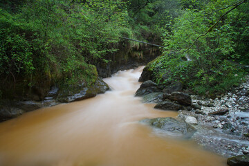 flowing water in a creek over the mountains in tuscany