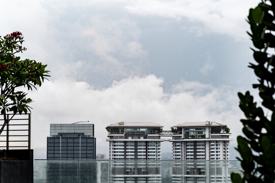 Twin rooftop towers framed by tropical plants, Kuala Lumpur, Malaysia