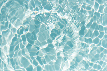 Blue water with ripples on the surface. Defocus blurred transparent blue colored clear calm water surface texture with splashes and bubbles. Water waves with shining pattern texture background.