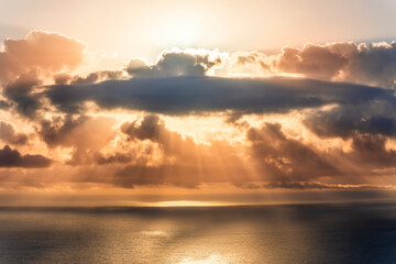 cloud in a form of flying sauser with light and shadows in amazing sunrise or sunset sky above water in beautisul seascape