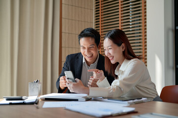 excited business people watching on mobile phone read a good news