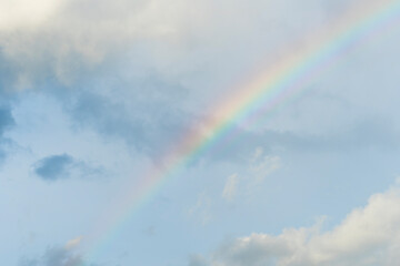 Dramatic blue clouds and rainbow in sunset sky. Amazing sky landscape. The sky that gives happiness and peace