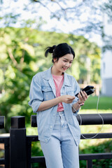 Female woman using external battery power bank charging her phone