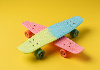 Two Colorful Penny Board Skateboard Stacked on Bright Yellow Background