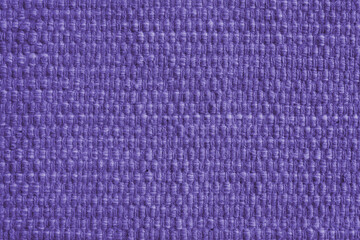 Texture of purple natural fabric with large weaving. Surface, structure of upholstery or carpet material, cloth background close up.