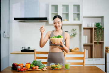 Woman Preparing Healthy Meal in Kitchen, Fit Woman Making Smoothie and salad with Fresh Ingredients at home. Active healthy lifestyle, clean eating concept