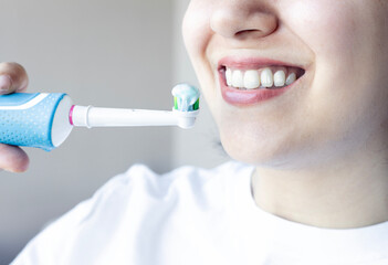 Woman smiling and brushing teeth. Dental care.	