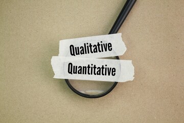 magnifying glass and sticker with the words quantitative and qualitative