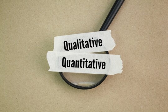 magnifying glass and sticker with the words quantitative and qualitative