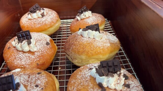dark chocolate pieces decorate Soft and fluffy Berliner. German Doughnut with swiss chocolate cream inside. High quality