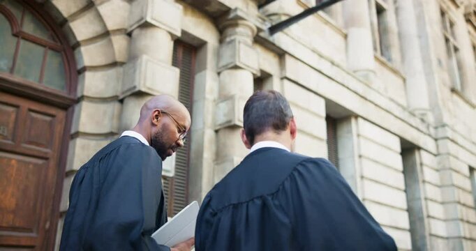 Judge, men and lawyer discussion in city for legal case collaboration, criminal justice and bail decision. Back, people and walking by courthouse for trial presiding, litigation verdict and planning
