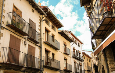 Narrow street with historical houses in the old town of Morella city