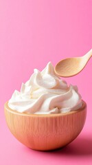 Creamy topping in wooden bowl