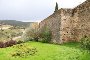 The walls that surrounds the old town of Morella city with beautiful gardens and the Trinquet tower