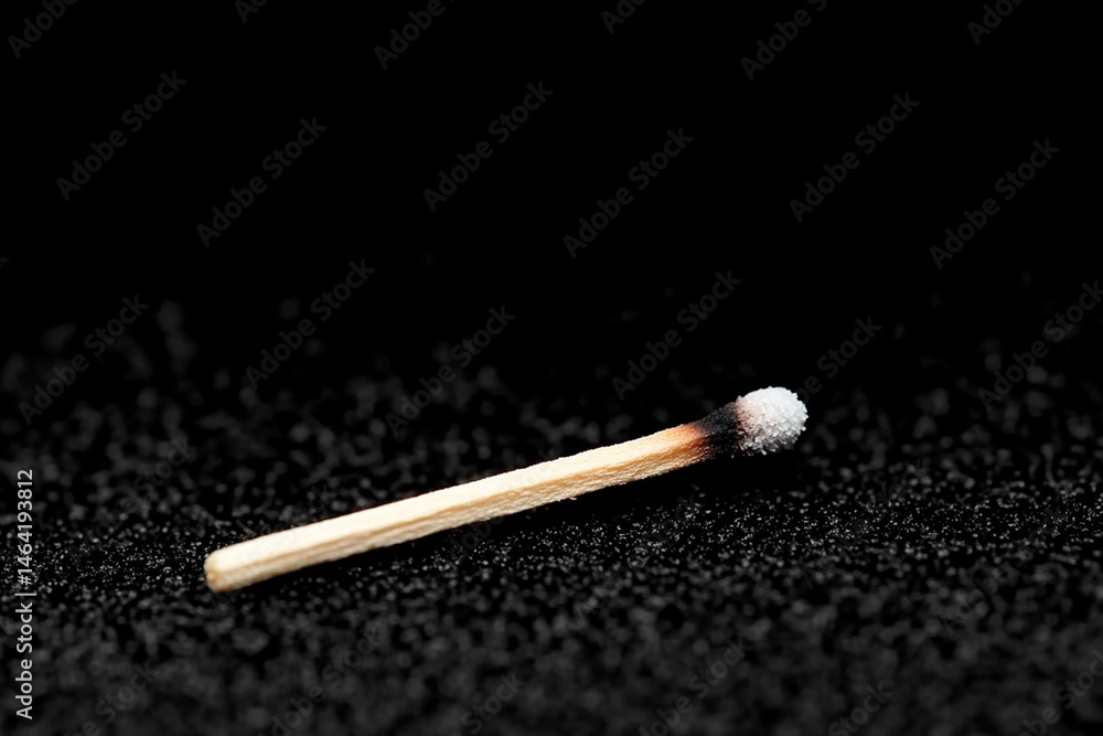 Poster single lit match illuminates dark minimalistic room creating a contrast of light and shadow