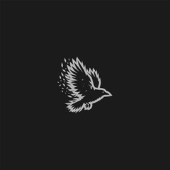 Naklejka premium Flying crow logo with fragmented feather silhouette style.