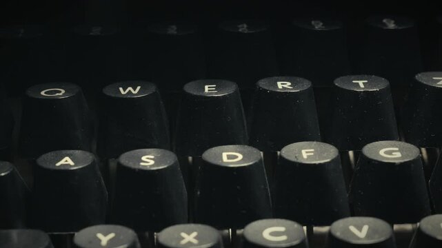 Electric retro typewriter character keys in dimly lit office CLOSE-UP