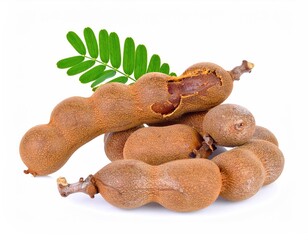 Tamarind pods still attached with green leaf, isolated on a surface: A close-up shot of freshly harvested tamarind pods, the rough, brown exteriors of the pods contrasting with the smooth.
