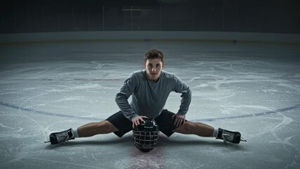 Young man stretching legs and preparing for ice hockey training. Caucasian athlete exercising to prevent injury on frozen rink with helmet before game. - Powered by Adobe