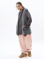 Fototapeta premium girl model in stylish clothes on a white background in the studio, fashion shooting.
