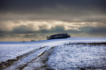 Zamarznięta polna droga na ośnieżonym polu. Pomorze zachodnie