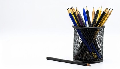A black mesh holder filled with colorful pencils and pens, with one pencil resting beside it, set against a plain white background