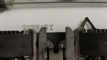 Germany word being typed on old vintage typewriter on white sheet of paper close-up