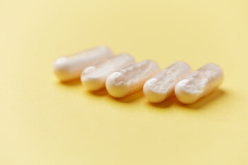 Coenzyme Q10 capsules. Antioxidants. Concept for a healthy dietary supplementation. Bright background. Soft focus. Close up. Copy space.