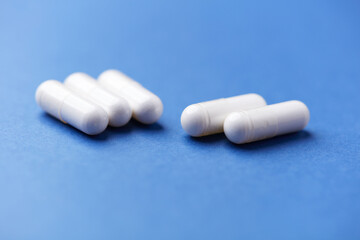 Arginine capsules on bright background. Soft focus. Close up. Copy space.	