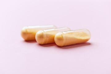 Coenzyme Q10 capsules. Antioxidants. Concept for a healthy dietary supplementation. Bright paper background. Soft focus. Close up. Copy space.	